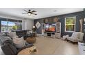 Comfortable living room featuring a sectional sofa, decorative wall art, and natural light from a window at 2614 Mead Ave, St Cloud, FL 34771