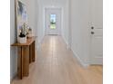 Bright and airy hallway with neutral walls, wood look tile flooring, and natural light at 2770 Sweet Acacia Dr, Clermont, FL 34711