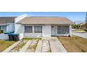 Charming home featuring white stucco, neutral roof, tidy front yard, and welcome decor at 2803 Charing Cross Way, Orlando, FL 32837