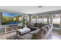 Comfortable living room features a large sectional sofa, a mounted TV, and tile floors at 2806 Polson Dr, Kissimmee, FL 34758