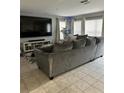 Cozy living room with a large sectional couch and big screen TV at 2806 Polson Dr, Kissimmee, FL 34758