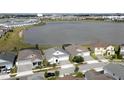 Aerial view of lakeside homes, displaying a community with water access and scenic surroundings at 2926 Wordsmith Rd, Kissimmee, FL 34746