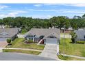 Aerial view of a neatly landscaped single-story home with a two-car garage in a quiet neighborhood at 3137 Timucua Cir, Orlando, FL 32837