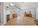 Living room featuring hardwood floors, a fireplace, and a high vaulted ceiling with stylish lighting at 3889 Biscayne Dr, Winter Springs, FL 32708