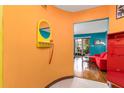Bright entryway showcasing colorful walls, unique decor, and hardwood floors leading to a cozy living area at 516 Orange Dr # 22, Altamonte Springs, FL 32701