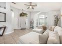 Bright living room with large windows, tile flooring, and modern decor at 525 Hardwood Cir, Orlando, FL 32828