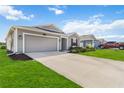 Charming single-story home with a well-manicured lawn, attached garage, and red accent shutters at 5347 Travertine St, Mount Dora, FL 32757
