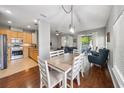 Inviting dining area flowing into a living space with a ceiling fan and a sliding glass door to the outside at 561 Pinebranch Cir, Winter Springs, FL 32708