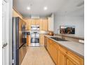 Modern kitchen featuring stainless steel appliances and natural wood cabinets, perfect for home cooking at 561 Pinebranch Cir, Winter Springs, FL 32708