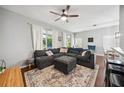 Comfortable living room features a large sectional couch, stylish area rug, and bright natural light from windows at 561 Pinebranch Cir, Winter Springs, FL 32708