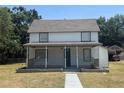 Charming two-story home featuring a covered front porch and a well-maintained lawn at 613 Michigan Ave, St Cloud, FL 34769