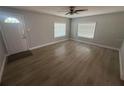Bright living room features sleek floors, neutral paint, and natural light from two windows at 613 Michigan Ave, St Cloud, FL 34769