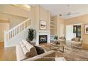 Comfortable living room featuring a cozy fireplace, plush seating, and a bright, open floor plan at 688 W Cranes Cir, Altamonte Springs, FL 32701