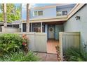 Inviting entrance with tiled patio, decorative wreath, and gated access at 702 Glasgow Ct, Winter Springs, FL 32708