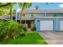 Charming blue two-story townhouse featuring a private garage and inviting landscaping at 702 Glasgow Ct, Winter Springs, FL 32708