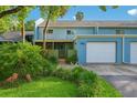Inviting two-story townhouse featuring a private garage and lush landscaping at 702 Glasgow Ct, Winter Springs, FL 32708