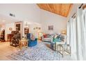 Bright living room features a wood ceiling, neutral walls, and a large rug at 702 Glasgow Ct, Winter Springs, FL 32708
