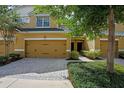 Charming townhouse featuring a two-car garage, manicured landscaping, and inviting front entrance at 8031 Enchantment Dr # Ge, Windermere, FL 34786