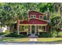 Charming home with a brick exterior, complemented by lush landscaping and a mature palm tree at 806 E Amelia St, Orlando, FL 32803