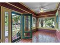 Cozy sunroom features brick floors, ceiling fan, and lots of natural light at 806 E Amelia St, Orlando, FL 32803
