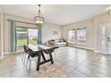 Bright dining area boasts tile flooring, a decorative light fixture, and a view of the outdoors at 812 Seneca Meadows Rd, Winter Springs, FL 32708