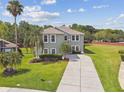 Beautiful two-story home featuring a well-kept lawn, mature trees, and a long driveway at 812 Seneca Meadows Rd, Winter Springs, FL 32708