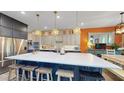 Beautiful kitchen with a large island, modern appliances, stylish pendant lighting, and custom cabinets at 8478 Elba Isle Ct, Windermere, FL 34786