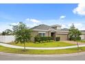 Well-manicured lawn surrounds this home with tidy landscaping and neutral colored exterior at 849 Avenal Ln, Davenport, FL 33837