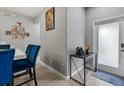 Inviting entryway with decorative table, art, and blue accents at 9009 Savannah Julip Ln, Orlando, FL 32832
