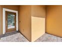 A well-lit porch and paneled front door with welcome mat on a textured brick surface at 9009 Savannah Julip Ln, Orlando, FL 32832