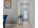 Inviting foyer with neutral walls, modern console table and tiled flooring for a minimalist appeal at 9009 Savannah Julip Ln, Orlando, FL 32832