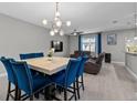 Open concept living room and dining area with stylish decor and comfortable seating at 9009 Savannah Julip Ln, Orlando, FL 32832