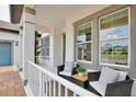 Cozy front porch featuring comfortable seating and decorative plants, perfect for relaxing outdoors at 10139 Austrina Oak Loop, Winter Garden, FL 34787