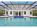 Back of the house featuring a beautiful pool area with a screened-in lanai and comfortable seating at 10139 Austrina Oak Loop, Winter Garden, FL 34787
