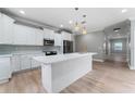 Bright, renovated kitchen with white cabinets, quartz counters, and stainless appliances at 1130 Hardy Ave, Orlando, FL 32803