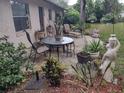 Outdoor patio with table, chairs, potted plants, and lawn furniture at 123 N High St, Lake Mary, FL 32746