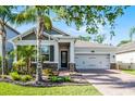 Charming home with a lush landscaped yard, brick pathway, and a two-car garage at 1232 Turnbridge Pl, Oviedo, FL 32765