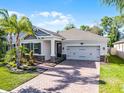 Well-maintained home featuring manicured landscaping and a brick paved driveway at 1232 Turnbridge Pl, Oviedo, FL 32765