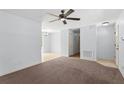 Open living space with carpet, a ceiling fan, and easy access to other rooms at 14878 Se 32Nd Ter, Summerfield, FL 34491
