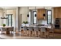 Gourmet kitchen featuring an island with seating, a custom range hood, and stainless steel appliances at 185 Sylvan Blvd, Winter Park, FL 32789