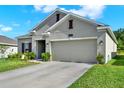Well-maintained single-story home with a spacious driveway and manicured lawn at 1880 Perch Hammock Loop, Groveland, FL 34736