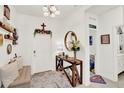 Bright foyer featuring a stylish table, decorative mirror, and a welcoming ambiance at 1880 Perch Hammock Loop, Groveland, FL 34736