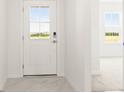 Bright entryway with tiled flooring, white door and view to exterior at 2009 Stone Wall Ct, Lake Hamilton, FL 33851