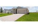 Exterior view of home showing driveway, lawn, landscaping, and neutral paint color at 2009 Stone Wall Ct, Lake Hamilton, FL 33851