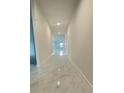 Bright hallway featuring glossy marble floors that lead to a naturally lit living space at 2009 Stone Wall Ct, Lake Hamilton, FL 33851