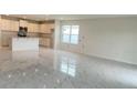 Open concept living room with an island kitchen, stainless appliances, and marble floors at 2009 Stone Wall Ct, Lake Hamilton, FL 33851