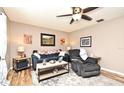 Inviting living room with stylish furniture, soft lighting, and a ceiling fan for added comfort at 2102 Urbana Ave, Deltona, FL 32725