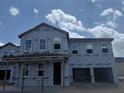 New construction featuring two-story home with large windows, garage, and covered porch at 22113 Amberbush Ct., Mount Dora, FL 32757