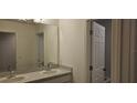 Bright bathroom with double sinks, a large mirror, and a separate toilet room at 222 Glass Onion Dr, Groveland, FL 34737
