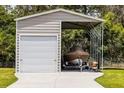 Large open metal garage with a rolling door and a boat with covering inside at 23203 Outback Ln, Eustis, FL 32736